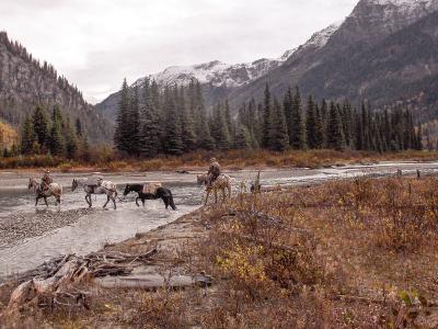 Crossing a river on horseback in British Columbia