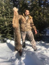 Hunter holding a Canadian Lynx Trophy