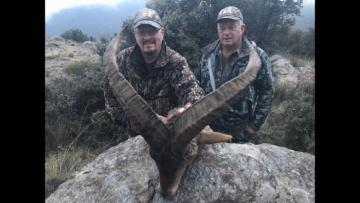 Two proud hunters with an ibex in Spain