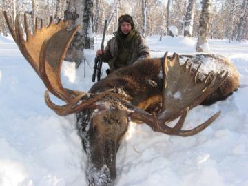 Hunter with a big Russian Moose