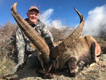 A proud hunter with his trophy Southeastern ibex