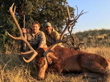 Proud hunter with his stag